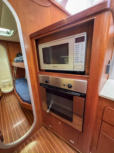 Adventure Yacht Photos Pics Antares 44i 2013 yacht kitchen with microwave and oven, wooden interior, and cozy cabin view.