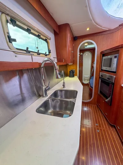 Adventure Yacht Photos Pics Luxurious Antares 44i 2013 yacht kitchen with modern appliances and sleek wood finish.