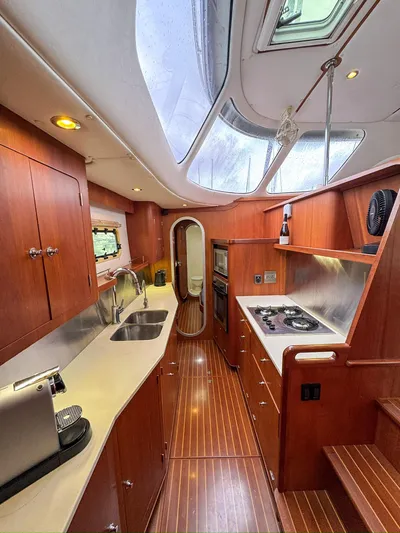 Adventure Yacht Photos Pics Luxurious Antares 44i yacht interior, featuring a modern kitchen with wood finishes, 2013 model.