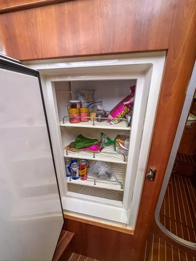 Adventure Yacht Photos Pics Refrigerator inside 2013 Antares 44i yacht, stocked with food and drinks.