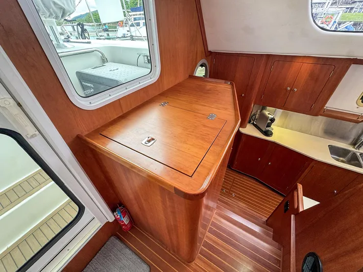 Adventure Yacht Photos Pics Interior of 2013 Antares 44i yacht with wooden cabinetry and stainless steel sink.