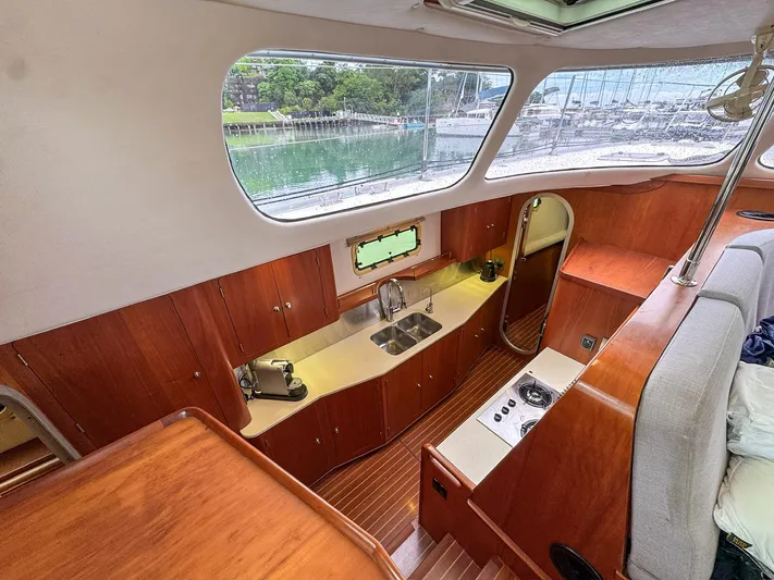 Adventure Yacht Photos Pics Interior of 2013 Antares 44i yacht with wooden cabinetry and modern kitchen amenities.