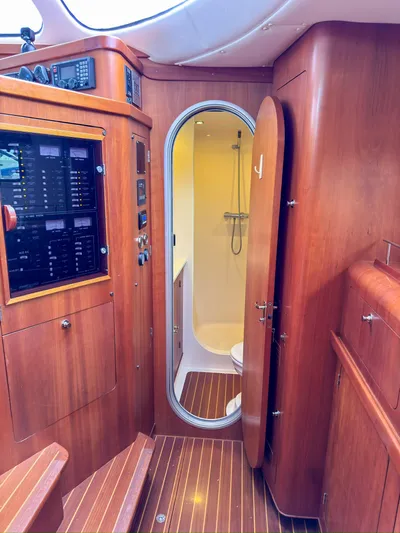 Adventure Yacht Photos Pics Interior of 2013 Antares 44i yacht, featuring wooden cabinetry and compact bathroom.