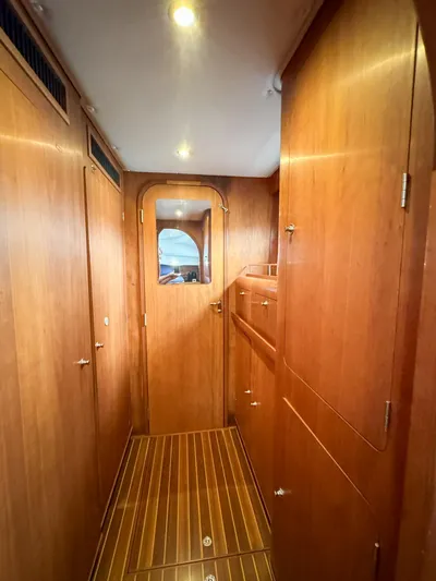 Adventure Yacht Photos Pics Interior hallway of 2013 Antares 44i yacht with wooden paneling and flooring.