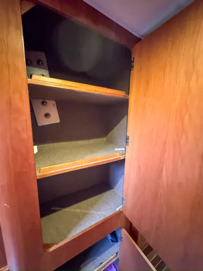 Adventure Yacht Photos Pics Wooden cabinet interior with shelves in a 2013 Antares 44i model.