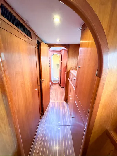 Adventure Yacht Photos Pics Interior hallway of 2013 Antares 44i yacht with wooden paneling and flooring.