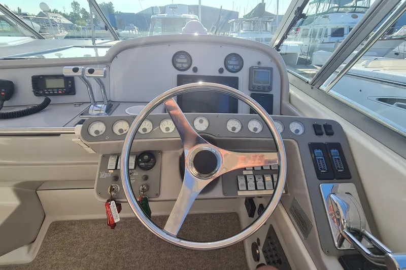  Yacht Photos Pics Steering wheel and dashboard of a 1998 Formula 41 Performance Cruiser boat.
