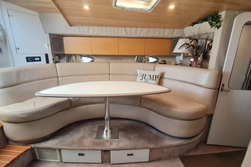  Yacht Photos Pics 1998 Formula 41 Performance Cruiser interior with curved seating and table.
