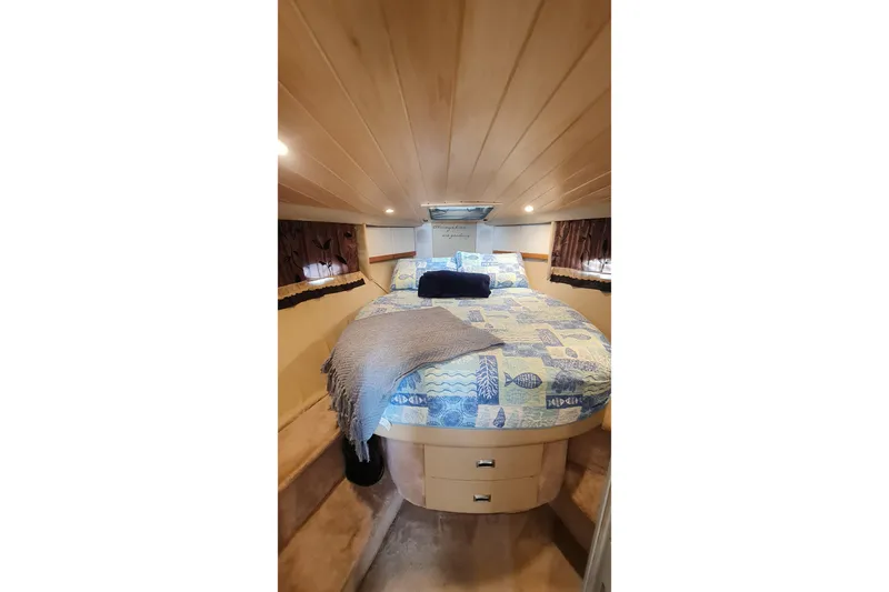  Yacht Photos Pics Cozy cabin interior of 1998 Formula 41 Performance Cruiser with nautical-themed bedding.