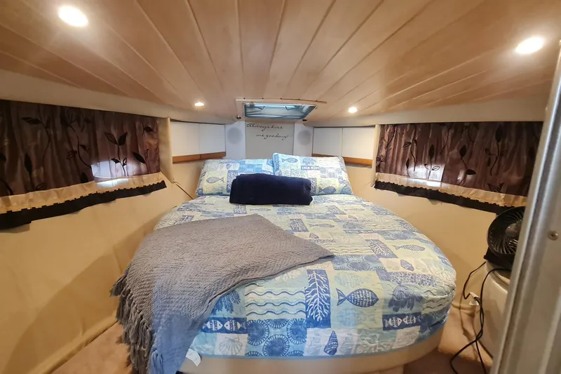  Yacht Photos Pics Cozy cabin interior of 1998 Formula 41 Performance Cruiser with nautical-themed bedding.