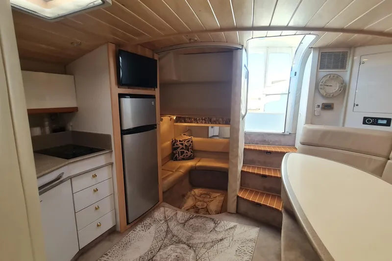  Yacht Photos Pics 1998 Formula 41 Performance Cruiser interior with kitchen, seating, and stairs.