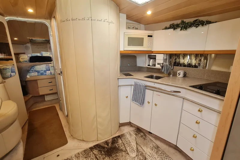  Yacht Photos Pics 1998 Formula 41 Performance Cruiser interior with kitchen and cozy bedroom.