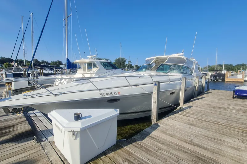  Yacht Photos Pics 1998 Formula 41 Performance Cruiser docked at a marina under clear blue skies.