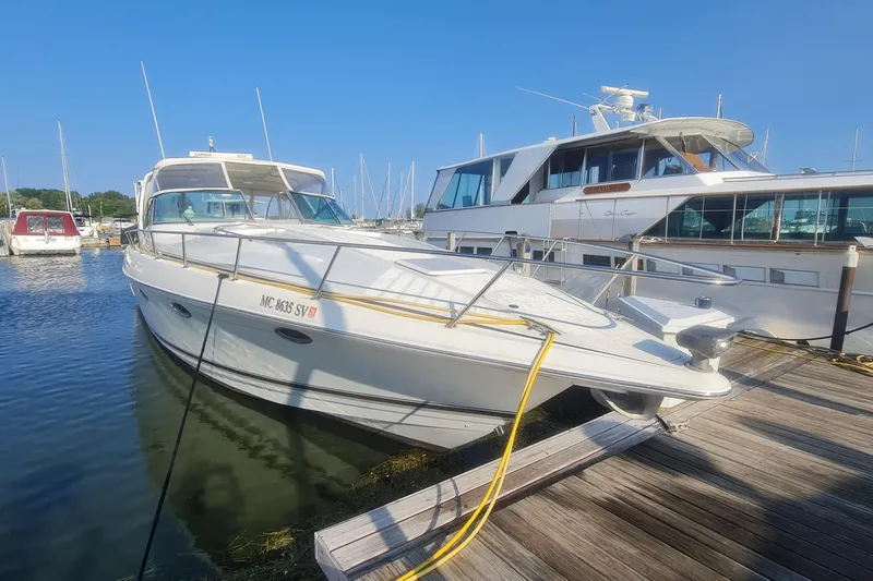  Yacht Photos Pics 1998 Formula 41 Performance Cruiser docked at marina under clear blue sky.
