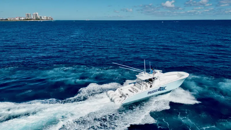  Yacht Photos Pics 2020 SeaHunter 46 CTS cruising on open ocean near city skyline.