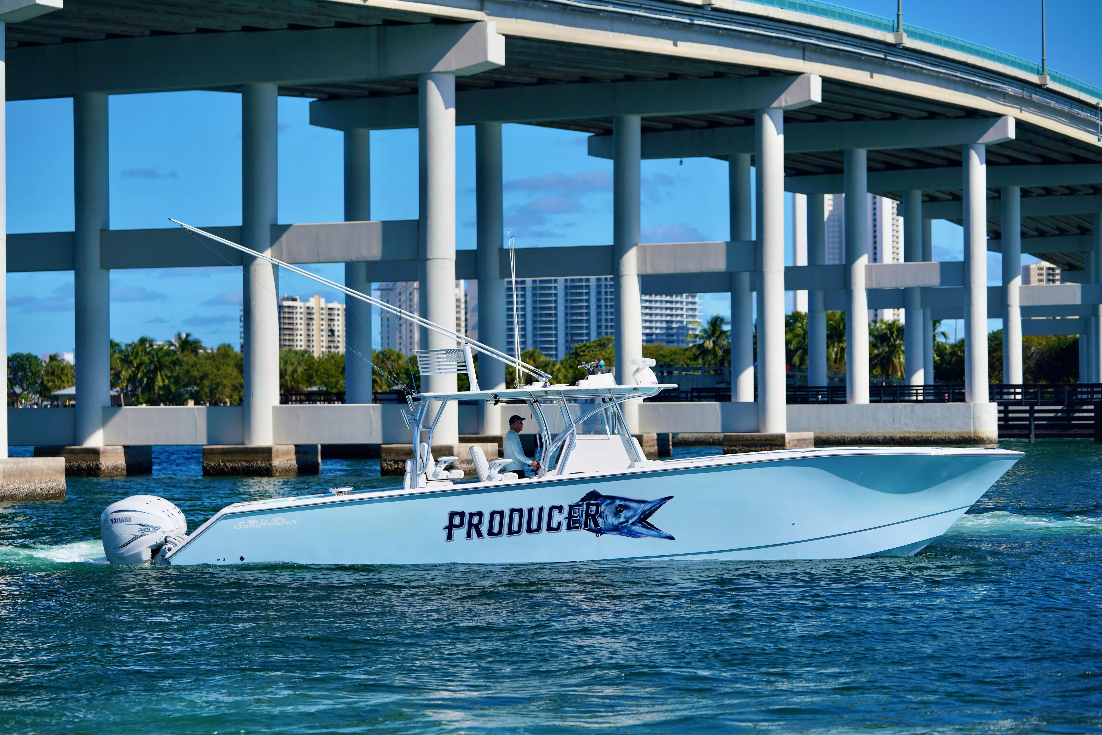  Yacht Photos Pics 2020 SeaHunter 46 CTS boat cruising under a bridge on a sunny day.