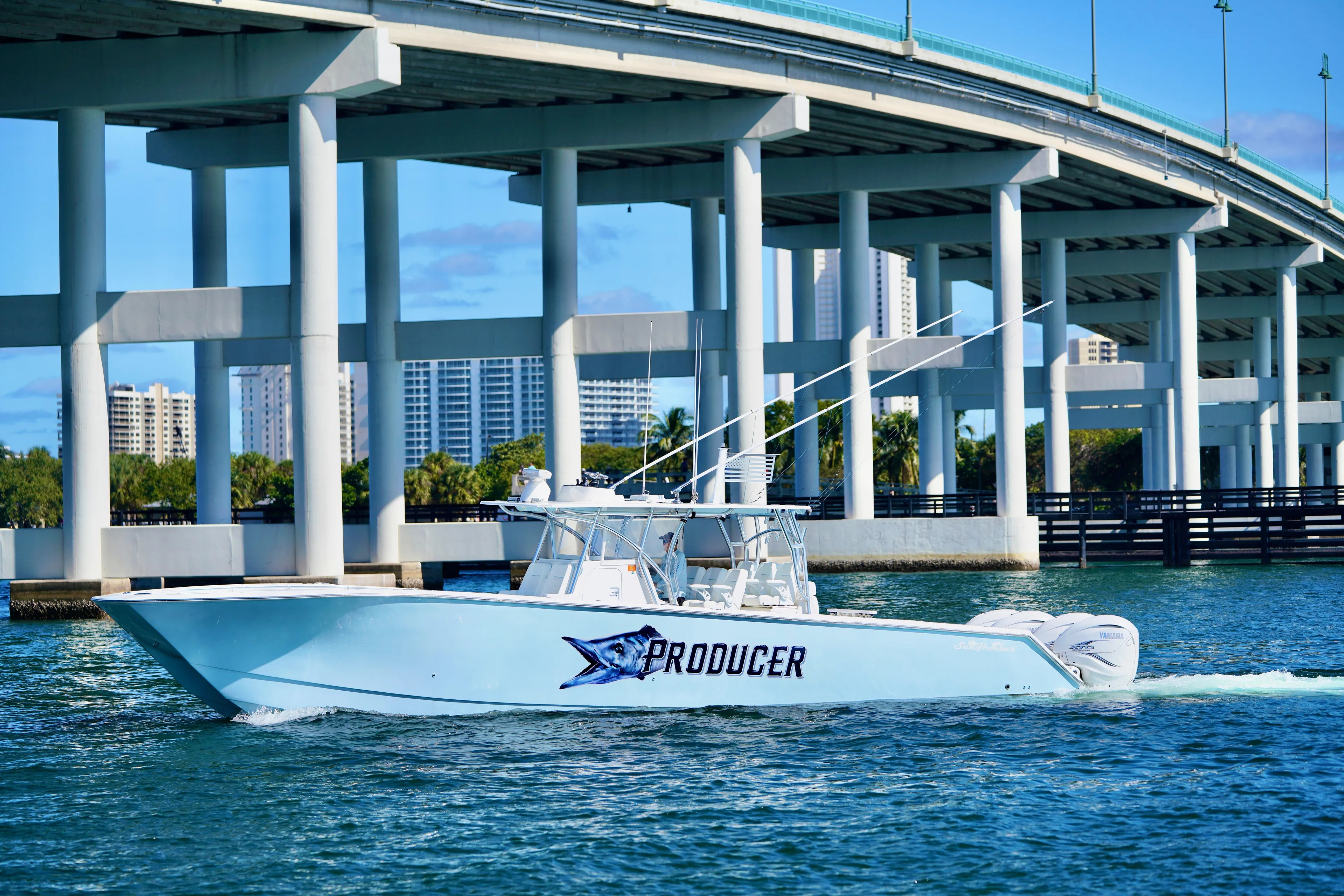  Yacht Photos Pics 2020 SeaHunter 46 CTS boat cruising under a bridge on a sunny day.