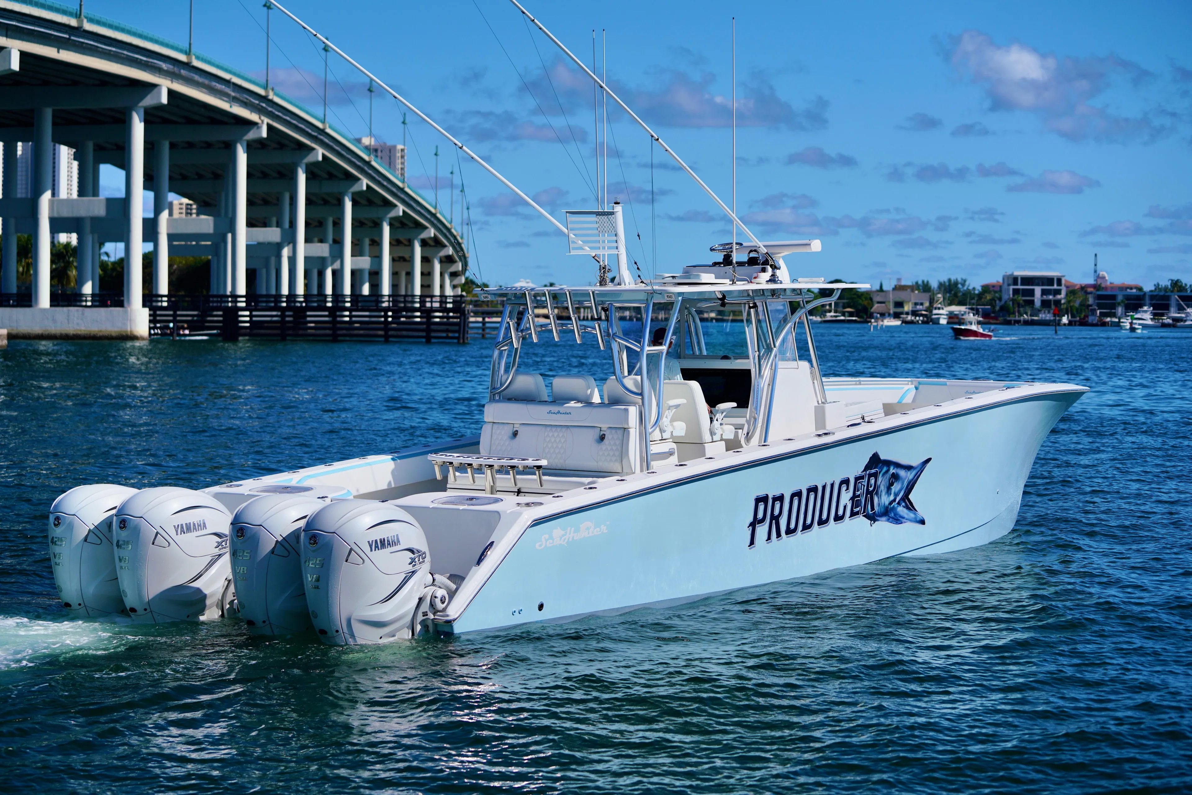  Yacht Photos Pics 2020 SeaHunter 46 CTS boat with triple Yamaha engines on water near a bridge.