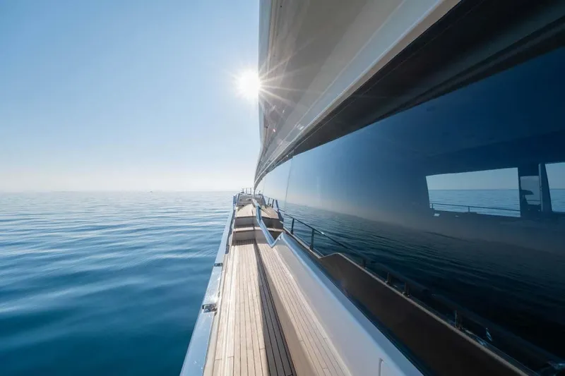  Yacht Photos Pics Side view of 2021 Ferretti Yachts 780 on calm sea with sun reflection.