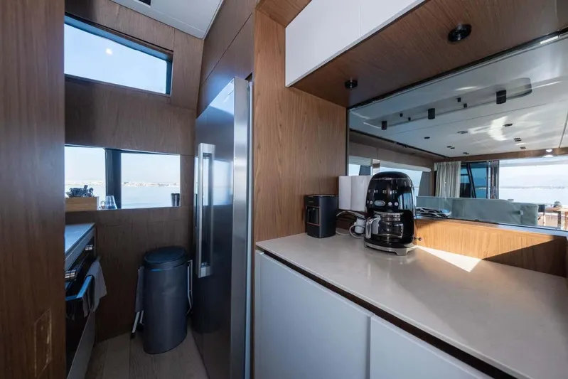  Yacht Photos Pics Modern kitchen interior on 2021 Ferretti Yachts 780, featuring sleek appliances and wood finishes.