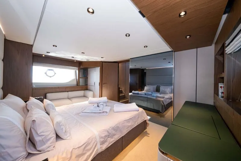  Yacht Photos Pics Luxurious bedroom interior of 2021 Ferretti Yachts 780, featuring elegant wood finishes and modern design.
