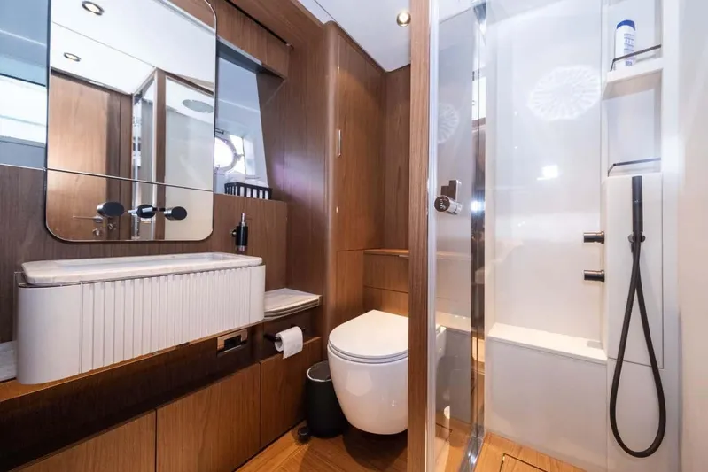  Yacht Photos Pics Luxurious bathroom in 2021 Ferretti Yachts 780, featuring modern fixtures and elegant wood finishes.