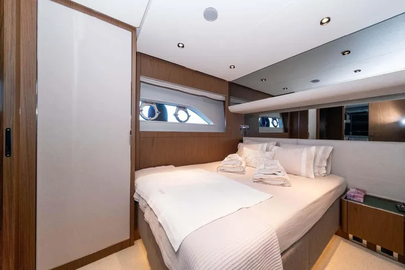  Yacht Photos Pics Luxurious bedroom interior of 2021 Ferretti Yachts 780 with elegant wood finishes and plush bedding.