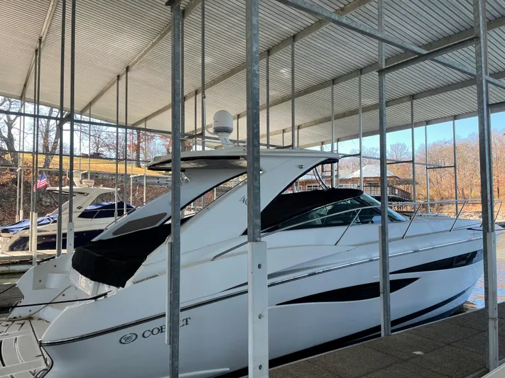  Yacht Photos Pics 2008 Cobalt 46 yacht docked in a covered marina, side view.