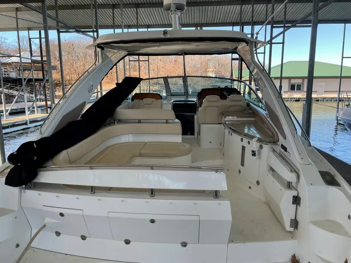  Yacht Photos Pics 2008 Cobalt 46 yacht with spacious seating, docked under a covered marina.