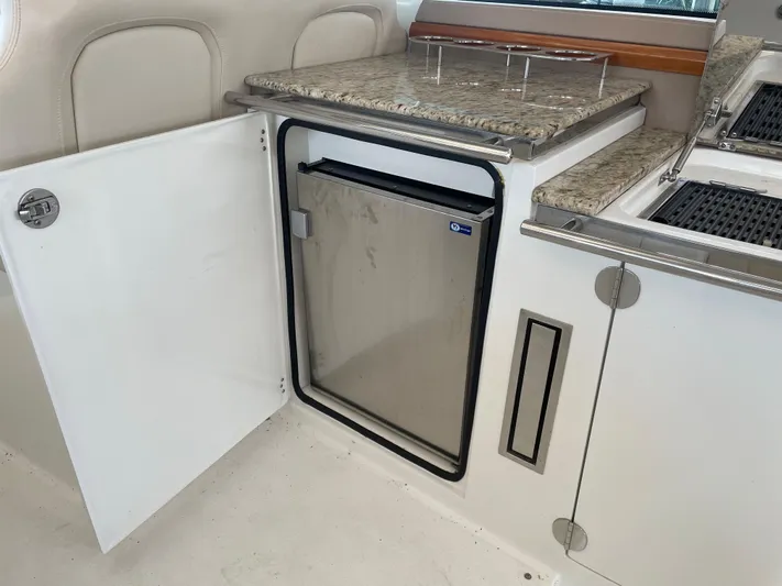  Yacht Photos Pics 2008 Cobalt 46 yacht interior with open cabinet and stainless steel mini fridge.