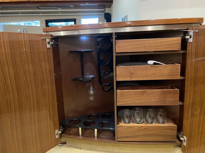 Yacht Photos Pics Open wooden cabinet with wine rack and glass storage on a 2008 Cobalt 46 yacht.