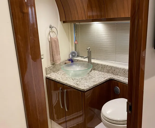  Yacht Photos Pics Luxurious bathroom in 2008 Cobalt 46 yacht with modern sink and wooden cabinetry.