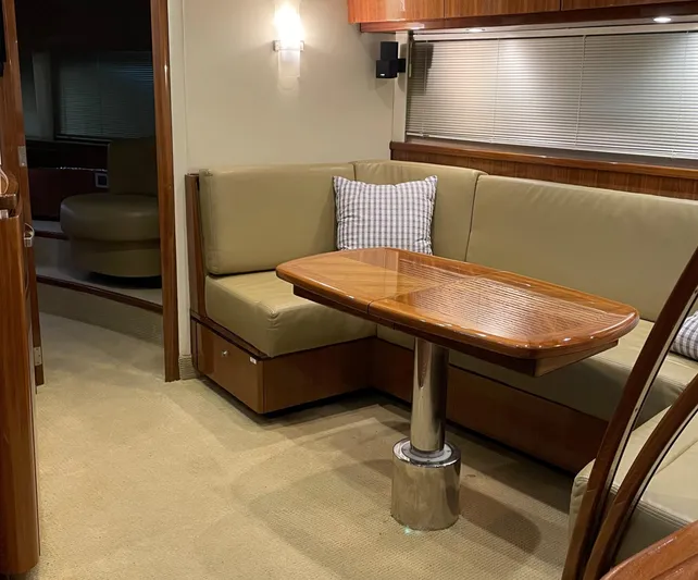 Yacht Photos Pics Interior of 2008 Cobalt 46 yacht with beige seating and wooden table.