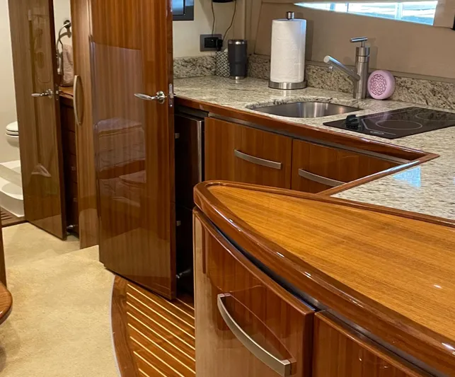  Yacht Photos Pics Luxurious kitchen interior of 2008 Cobalt 46 yacht with wood cabinetry and granite countertops.