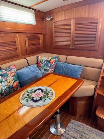  Yacht Photos Pics Cozy Sabre 38 yacht interior with floral cushions and wooden table, 2005 model.