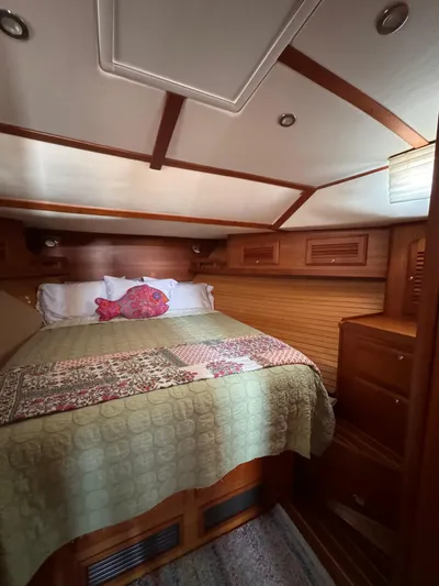  Yacht Photos Pics Cozy cabin interior of 2005 Sabre 38 sailboat with wood finish and quilted bedding.