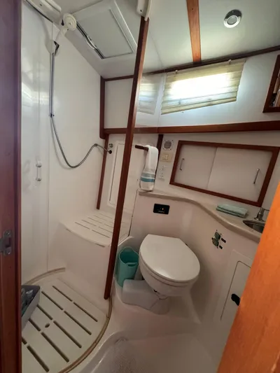  Yacht Photos Pics 2005 Sabre 38 yacht bathroom with shower, toilet, and storage cabinets.