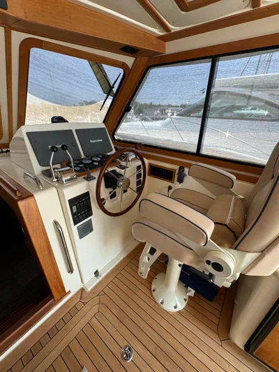  Yacht Photos Pics Interior of 2005 Sabre 38 boat with helm, steering wheel, and captain's chair.