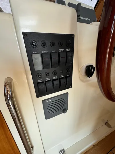  Yacht Photos Pics Control panel of a 2005 Sabre 38 boat with switches and steering wheel.