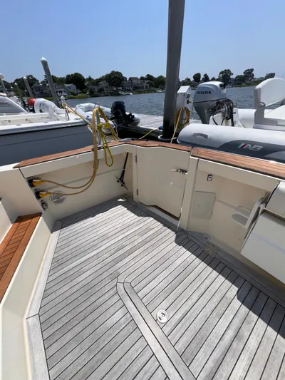  Yacht Photos Pics 2005 Sabre 38 boat deck with wood flooring and docked view.