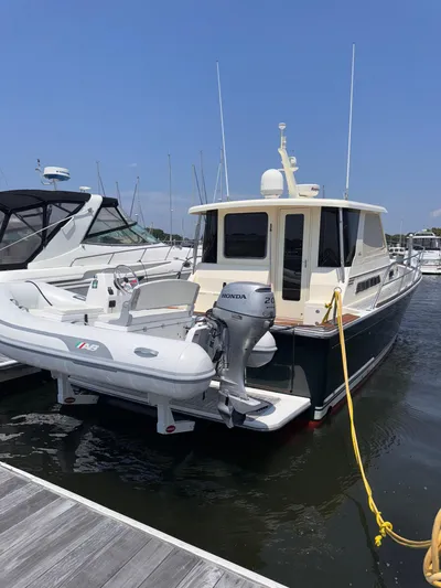  Yacht Photos Pics 2005 Sabre 38 yacht docked with inflatable boat attached.