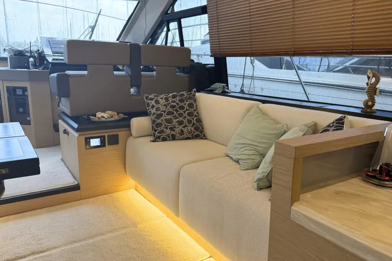  Yacht Photos Pics Luxurious interior of 2020 Beneteau Monte Carlo 52 yacht with plush seating and elegant decor.