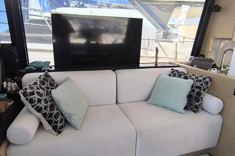  Yacht Photos Pics Luxurious interior of 2020 Beneteau Monte Carlo 52 yacht with plush seating and cushions.