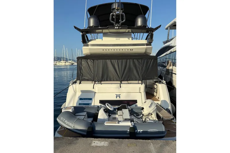  Yacht Photos Pics 2020 Beneteau Monte Carlo 52 yacht docked with inflatable boat on deck.