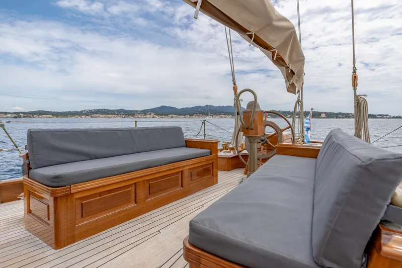 Armide Yacht Photos Pics 1938 Custom By Classic Works yacht deck with cushioned seating and scenic ocean view.