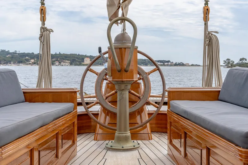 Armide Yacht Photos Pics 1938 Custom By Classic Works boat helm with wooden wheel and seating.