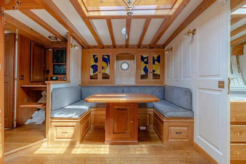 Armide Yacht Photos Pics 1938 Custom By Classic Works yacht interior with wooden dining area and skylight.