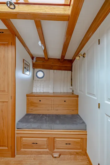 Armide Yacht Photos Pics 1938 Custom By Classic Works interior with wooden beams, built-in seating, and storage drawers.