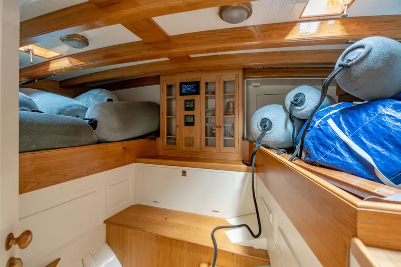 Armide Yacht Photos Pics 1938 Custom Classic Works boat interior with wooden cabinetry and storage space.