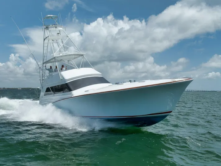 Bird Dog Yacht Photos Pics 1989 Jim Smith Custom Convertible yacht cruising on open water under a cloudy sky.